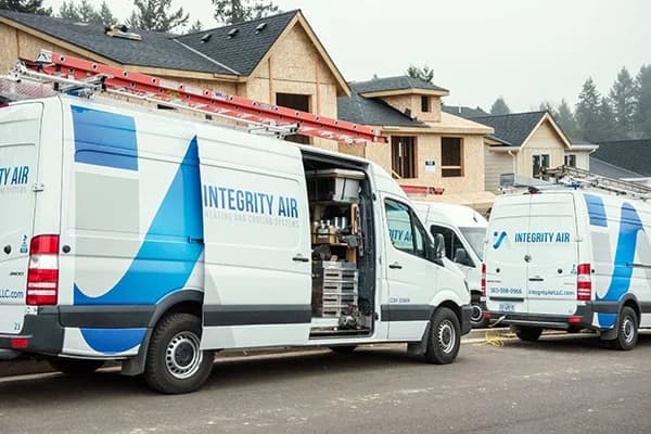 Integrity Air HVAC vans at new construction site in Portland
