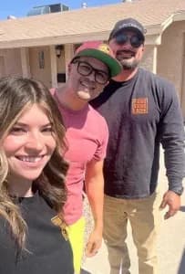 our phoenix roofing and repair team taking a photo with another happy customer