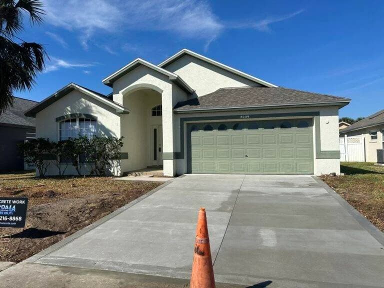 concrete driveway in front of large home, just recently finished