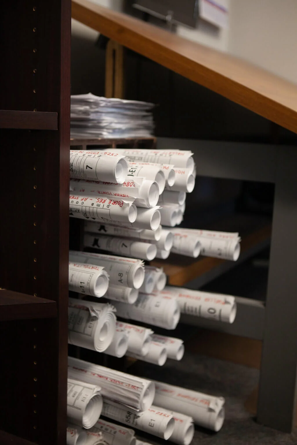 Stacked electrical project plans at Cascade Electric in Tucson, Arizona