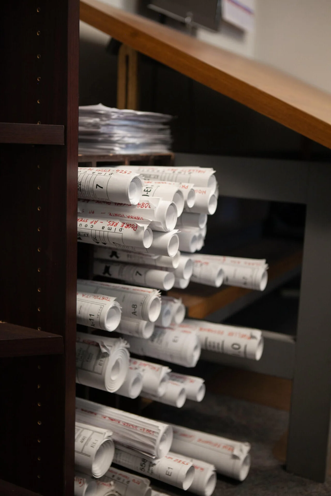 Stacked electrical project plans at Cascade Electric in Tucson, Arizona