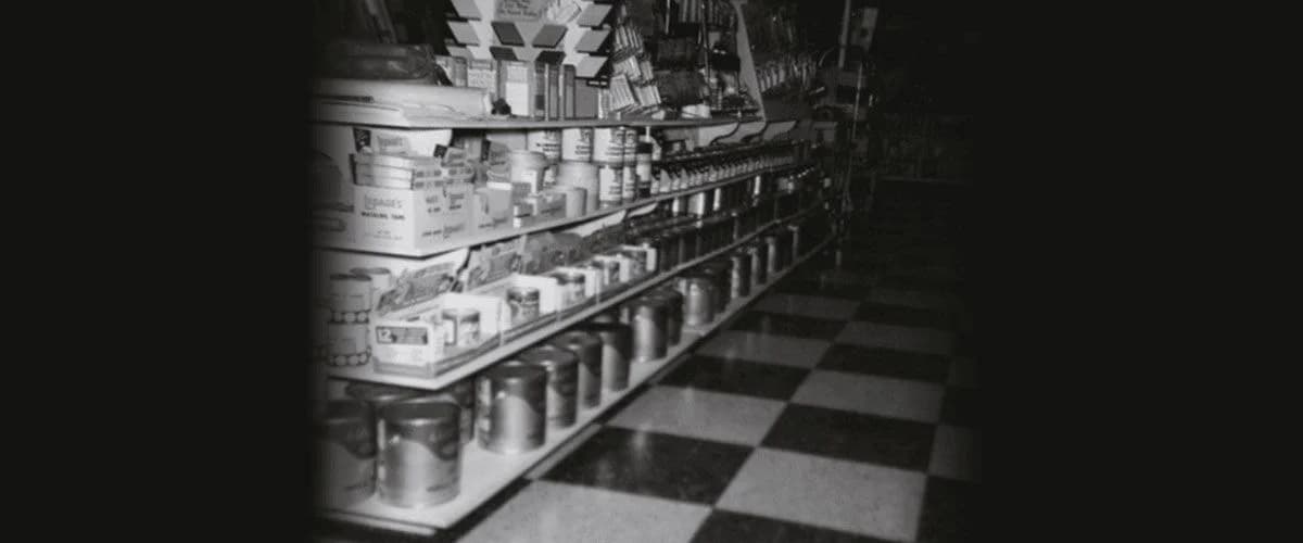 buckets of paint on a shelf on the store.