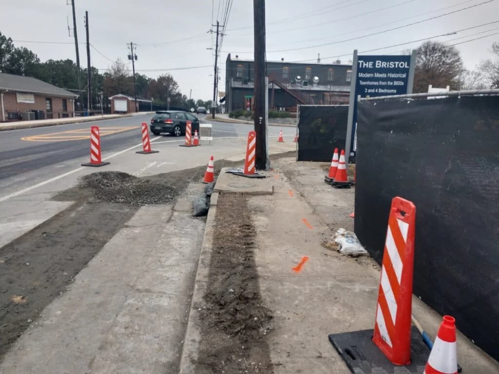 Road construction services with curbs and gutters by paving contractor at Bristol site