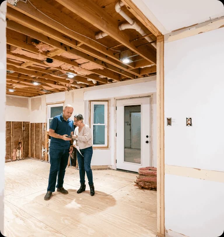 Two people inspecting a home renovation project.