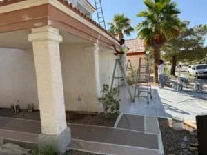 Exterior painting in Las Vegas, NV by Eclipse Painting showing professional painters on ladders refinishing a residential home exterior under the Nevada sun.