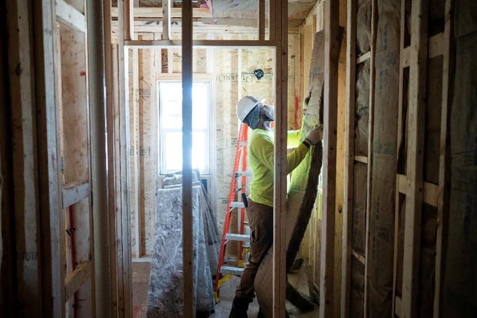 Technician installing insulation