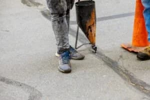 Concrete repair work- A concrete worker filling the gaps with the concrete