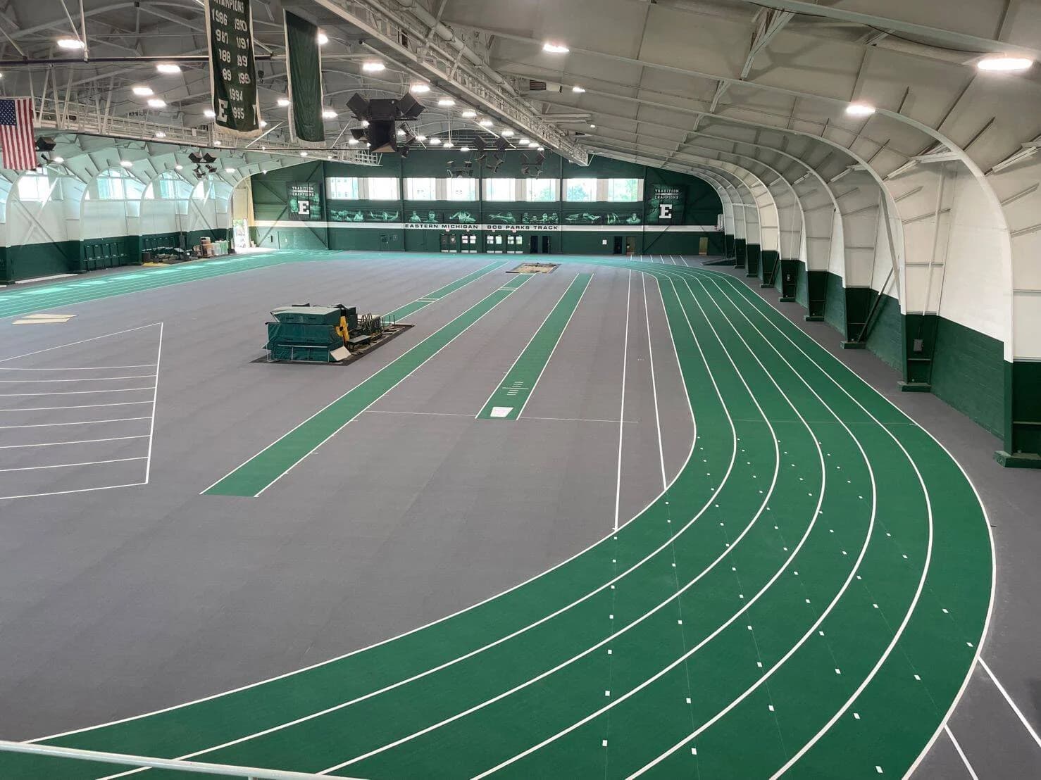 Beautifully designed track and field track that showcases a green theming and emphasizes commercial athletic flooring