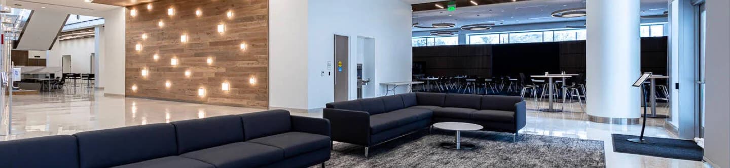 Diverzify headquarters, which includes seating areas, a white marble floor, and a nice wooden wall with effective lighting