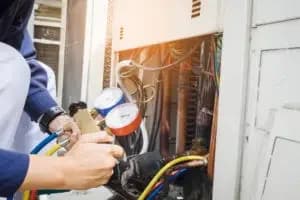 HVAC contractor servicing residential air conditioning system in Philadelphia, PA