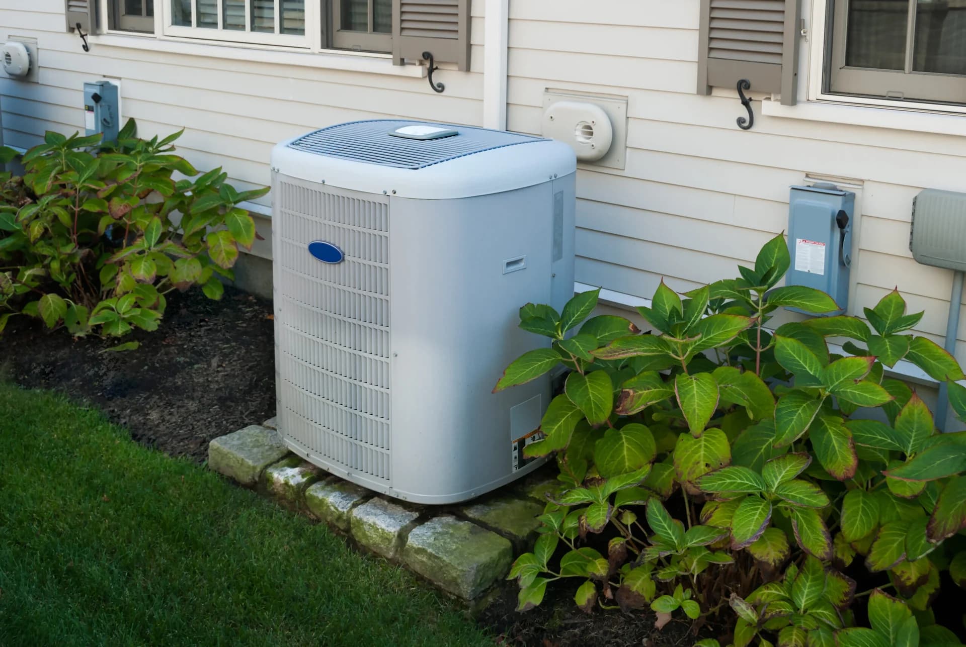 Heat pump installed outside Utah home — Utah heat pump rebates guide