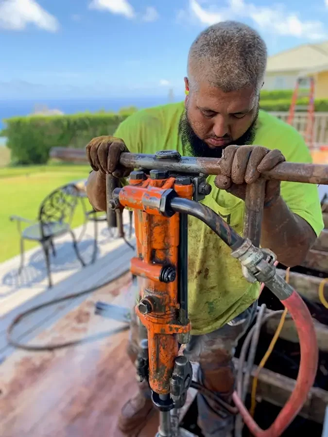 Foundation Systems crew member drilling.