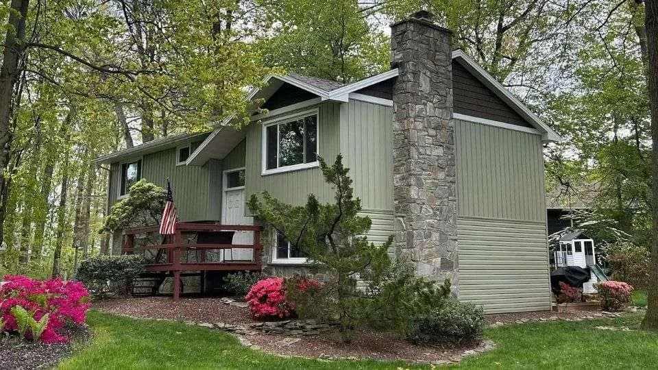 After Image with upgraded siding and new green siding color