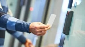 Employee using their ID card at the door access control system