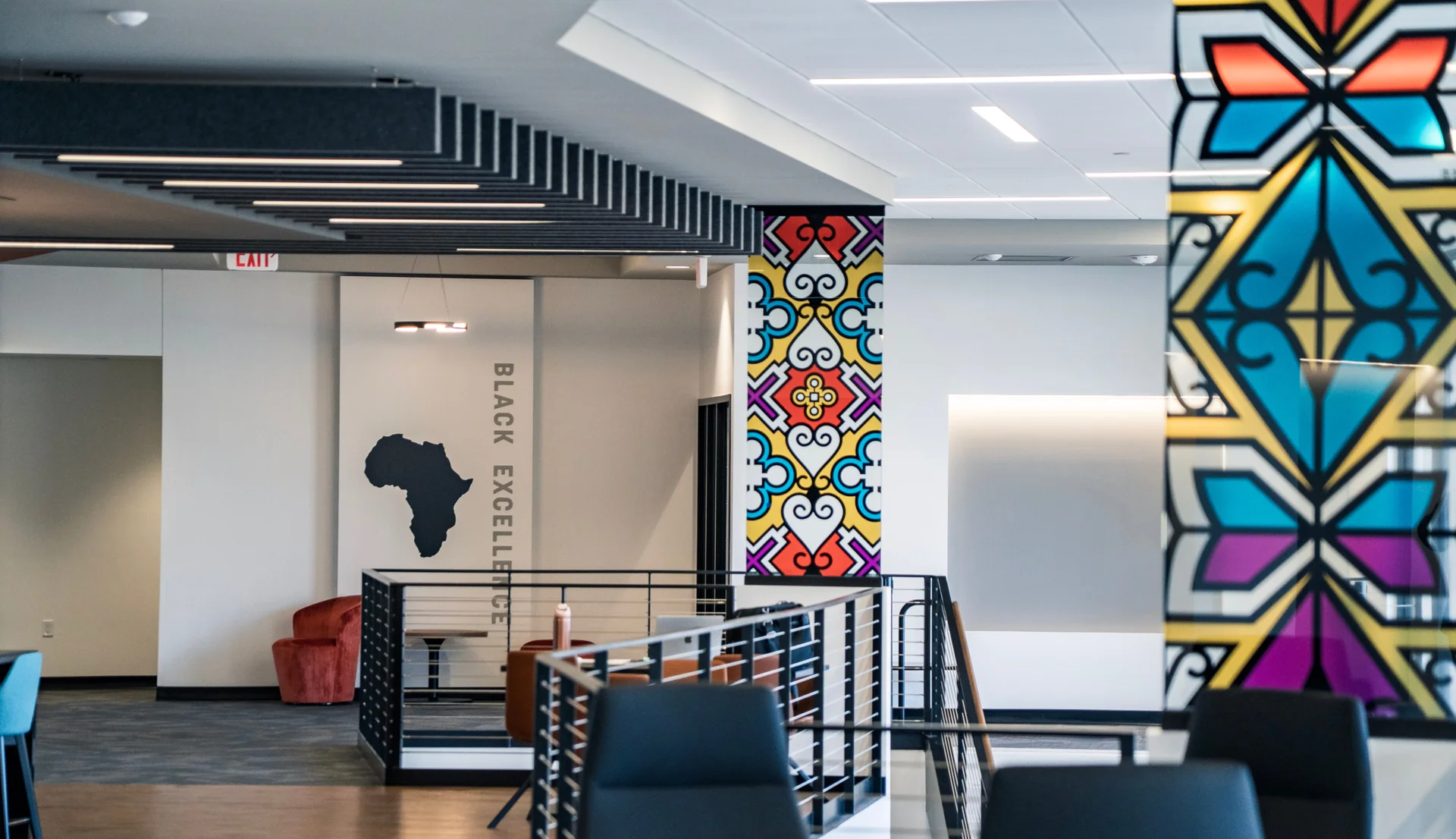 Interior gathering space at The Center for Black Excellence and Culture featuring colorful artwork, modern architecture