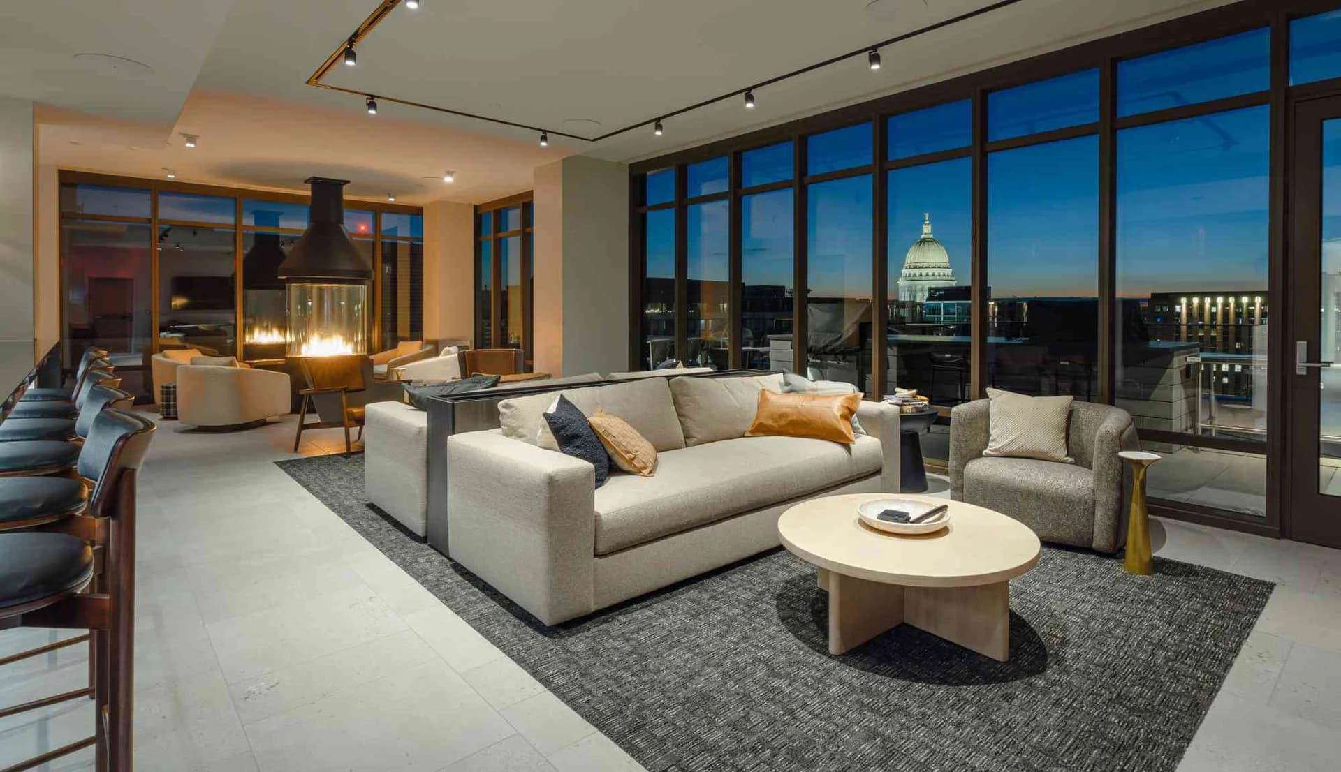 Resident community lounge at One09 Apartments with views of the Wisconsin State Capitol