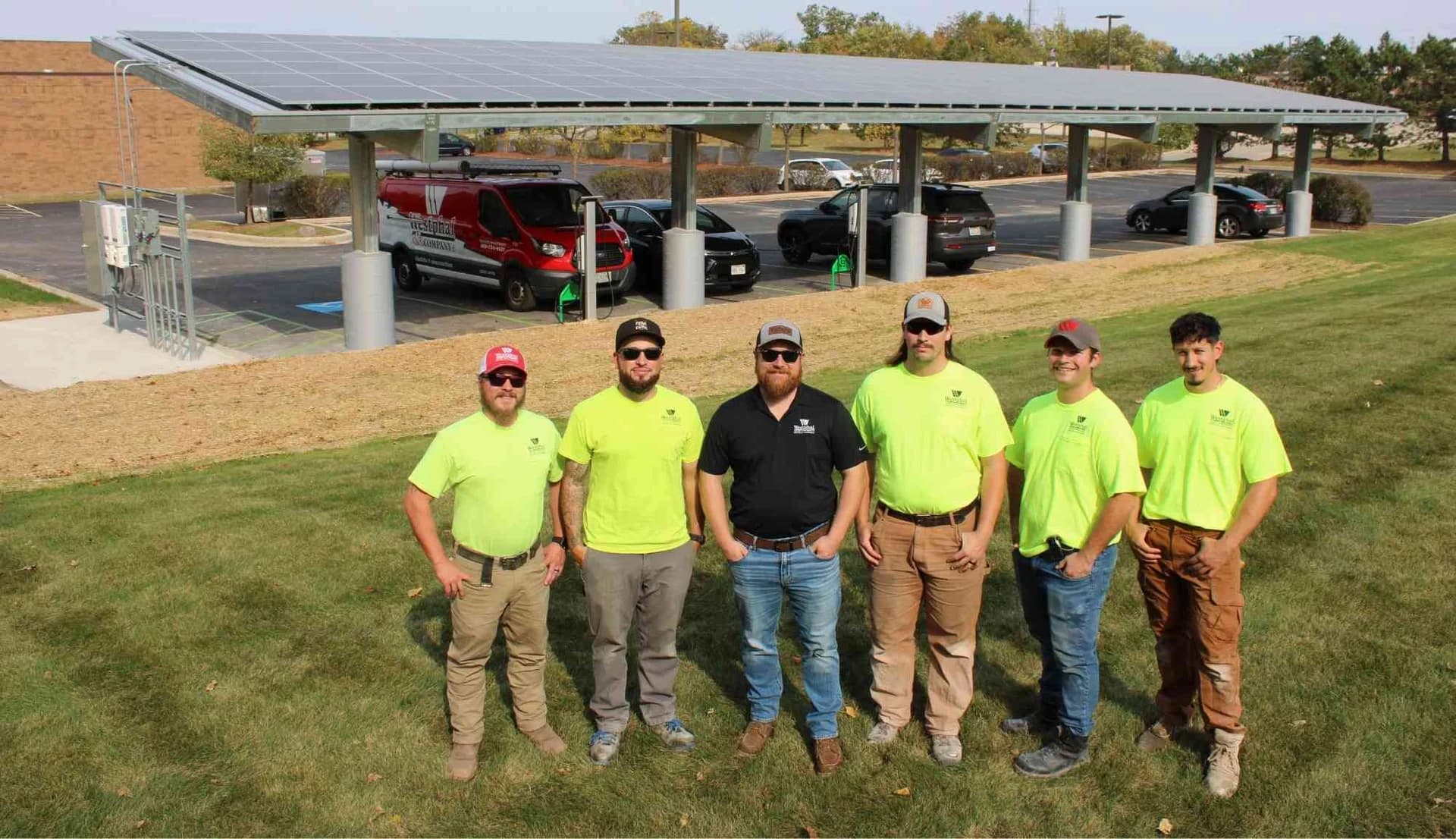 Westphal and Company solar installation crew standing in front of the completed solar canopy at IBEW Local 494.