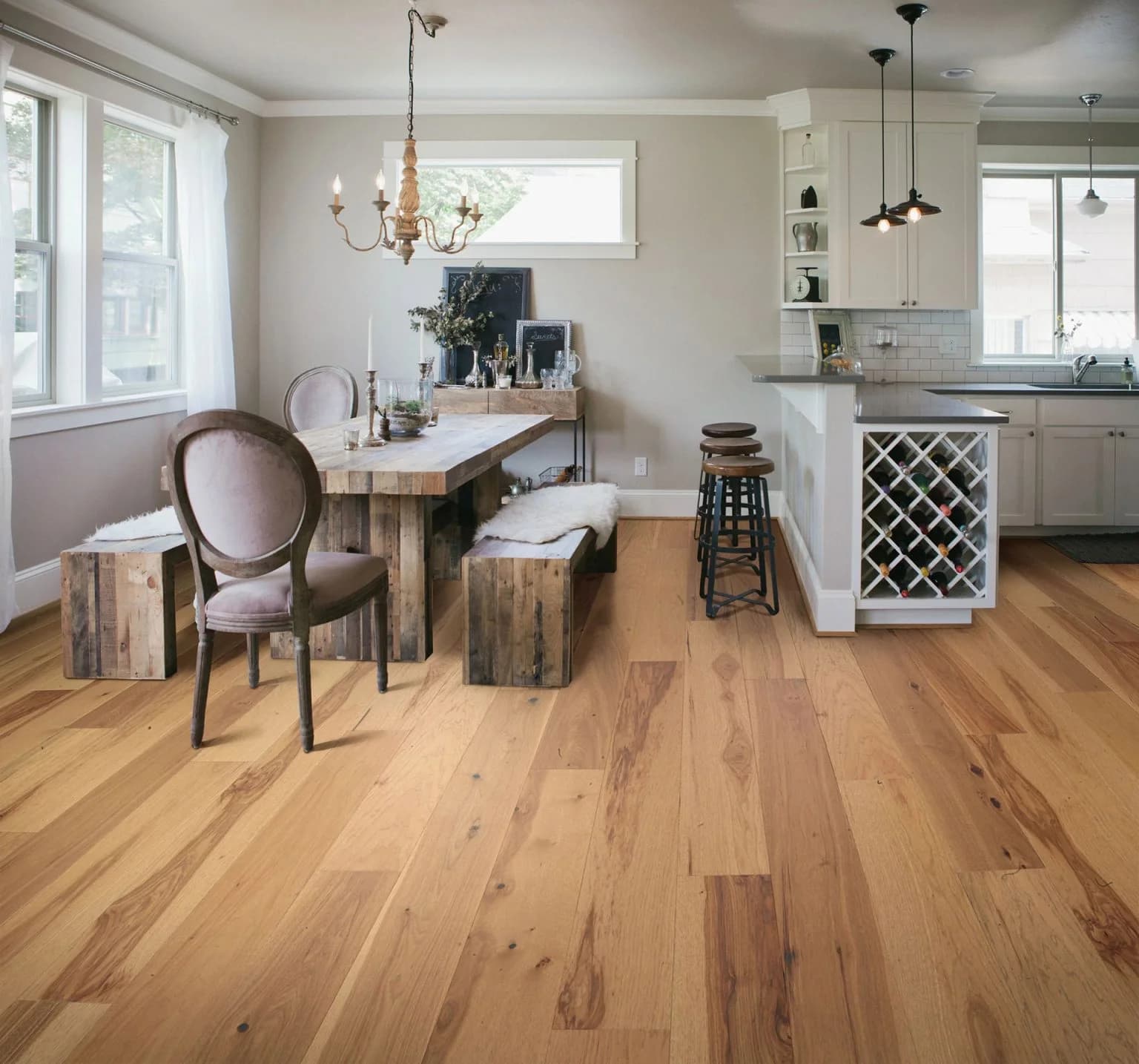 kitchen area with light brown hardwood flooring featuring wood style bench dining room table