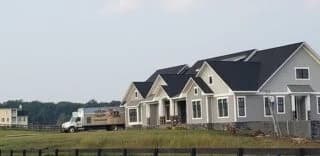 Southland Insulators truck parked next to a new large home.