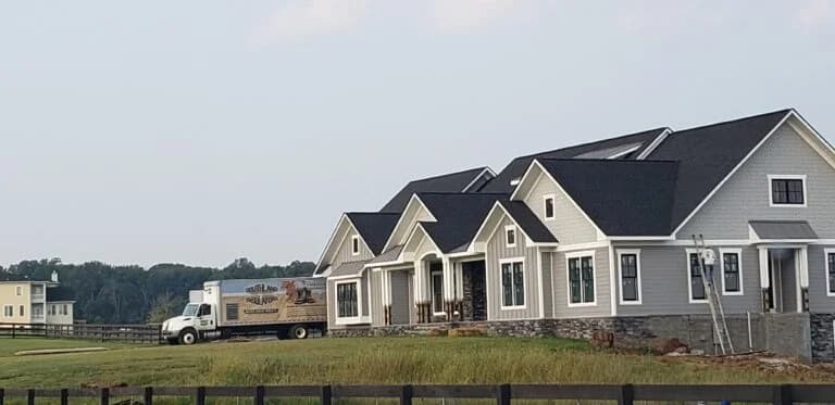 Southland Insulators truck parked next to a new large home.