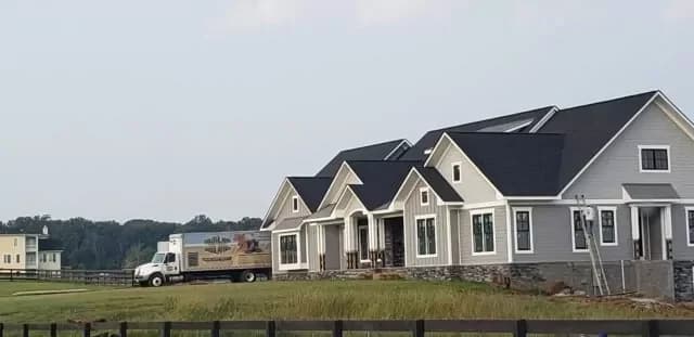 Southland Insulators truck parked next to a new large home.
