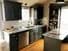 Kitchen cabinet painting job in Lee's Summit Missouri after two coats of Diamond Vogel paint color Zen Retreat in a satin sheen