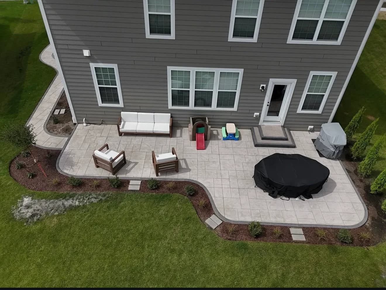 Stamped concrete patio with cobblestone border
