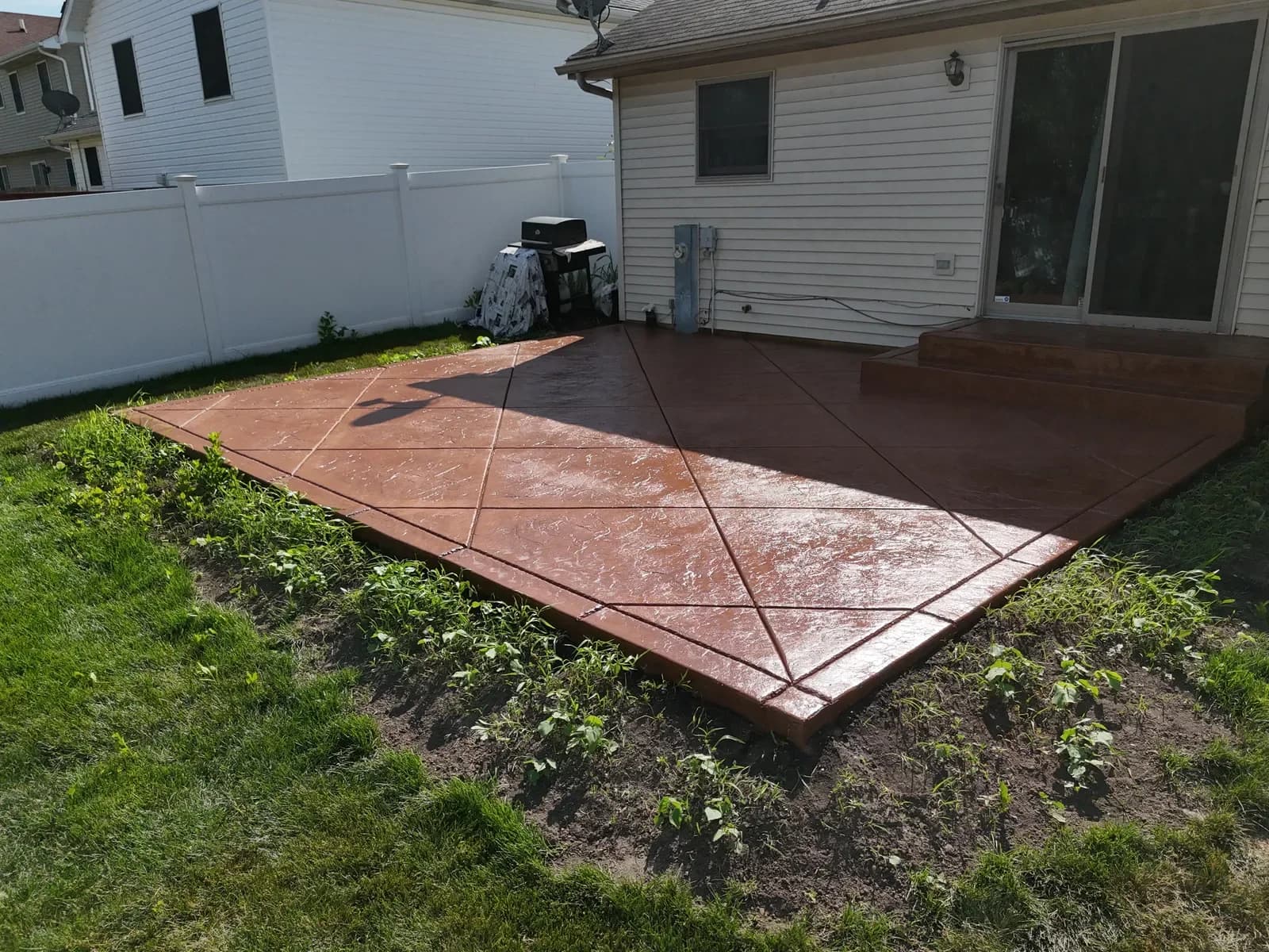 Bold terracotta stained concrete patio — aerial drone view