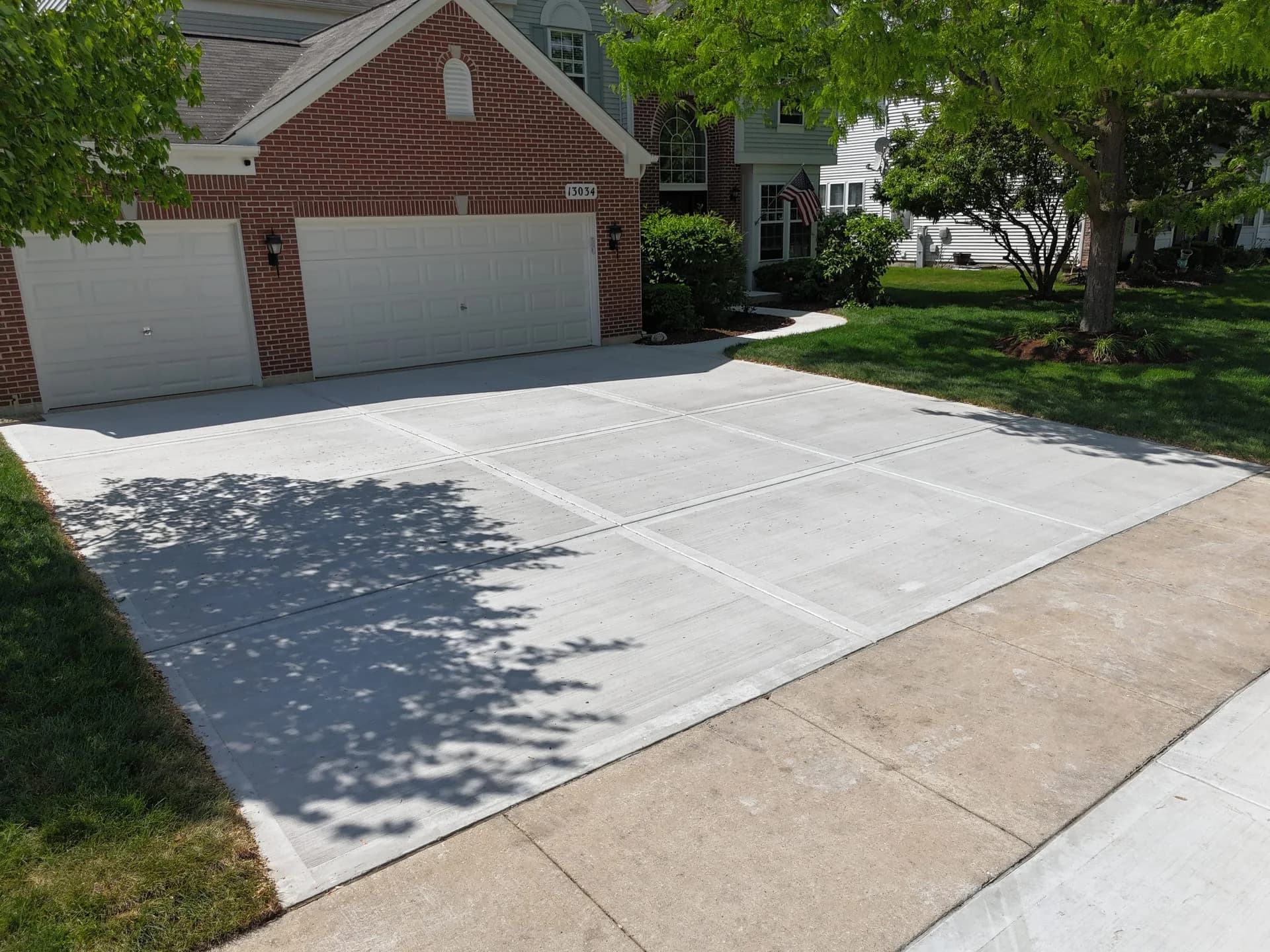 New concrete driveway in residential neighborhood