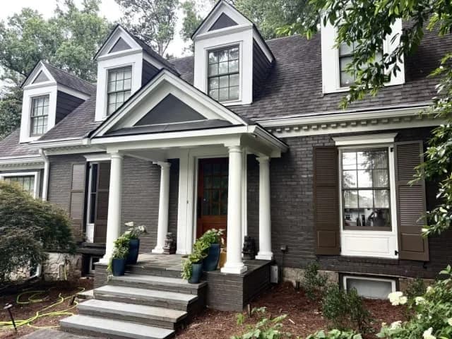 Dark brick colonial exterior with white columns painted by OVO Painting in Atlanta