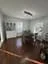 Formal dining room with white wainscoting, dark hardwood floors, and natural light from tall windows painted by OVO Painting in Atlanta