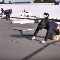 commercial roofer installing foam insulation