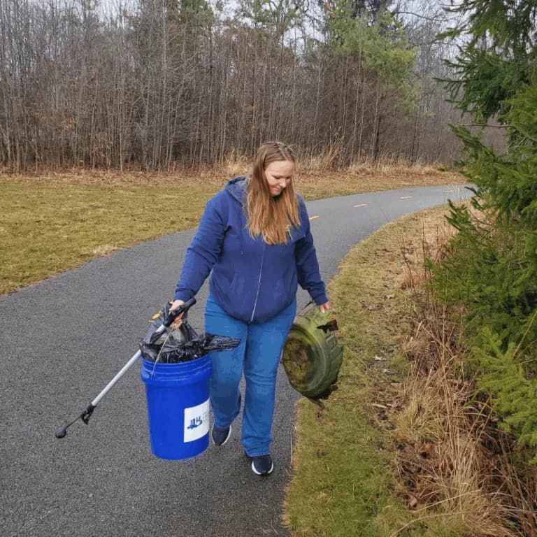 Custom Air employees give back during Service Day. This employee is shown picking up trash.