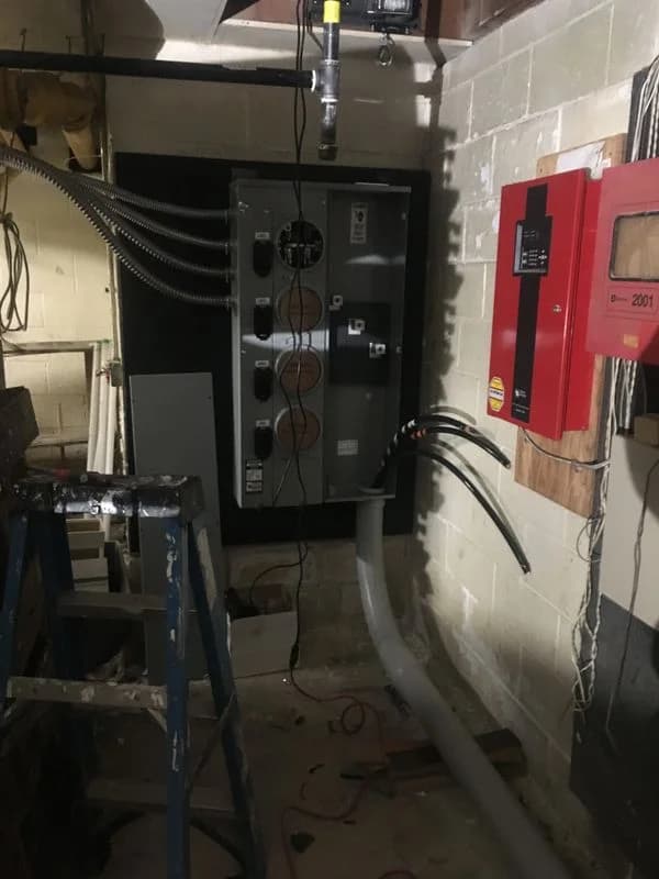 Electrical fuse boxes and power lines in the basement of an old apartment building