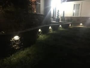 Beautiful colorful illuminated lamp in the garden in misty night
