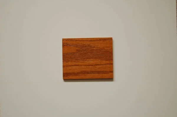 Sample of red oak wood with a dark natural stain showcasing the detailed grain and warm hue, ideal for the custom, high-quality cabinetry created by C&S Cabinets.