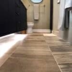 A modern bathroom featuring stylish large-format tiles installed by Orange Cat Flooring in Atlanta, GA.
