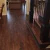 A hallway and staircase with beautifully installed dark hardwood flooring, showcasing the craftsmanship of Orange Cat Flooring in Atlanta, GA.