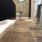 A modern bathroom featuring stylish large-format tiles installed by Orange Cat Flooring in Atlanta, GA.