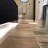 A modern bathroom featuring stylish large-format tiles installed by Orange Cat Flooring in Atlanta, GA.