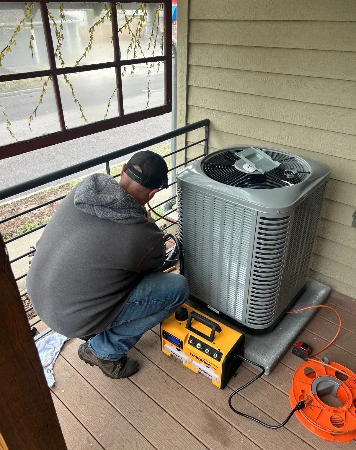 Professional HVAC technicians installing a new air conditioning unit in a Denver home for reliable, energy-efficient cooling