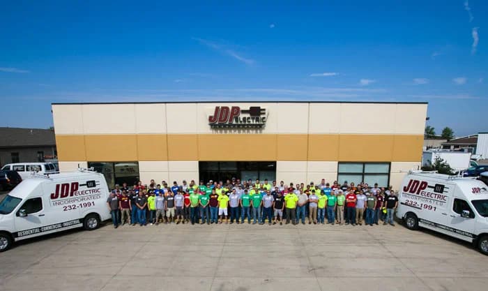 JDP team in front of the JDP building in Fargo, electricians and entire team