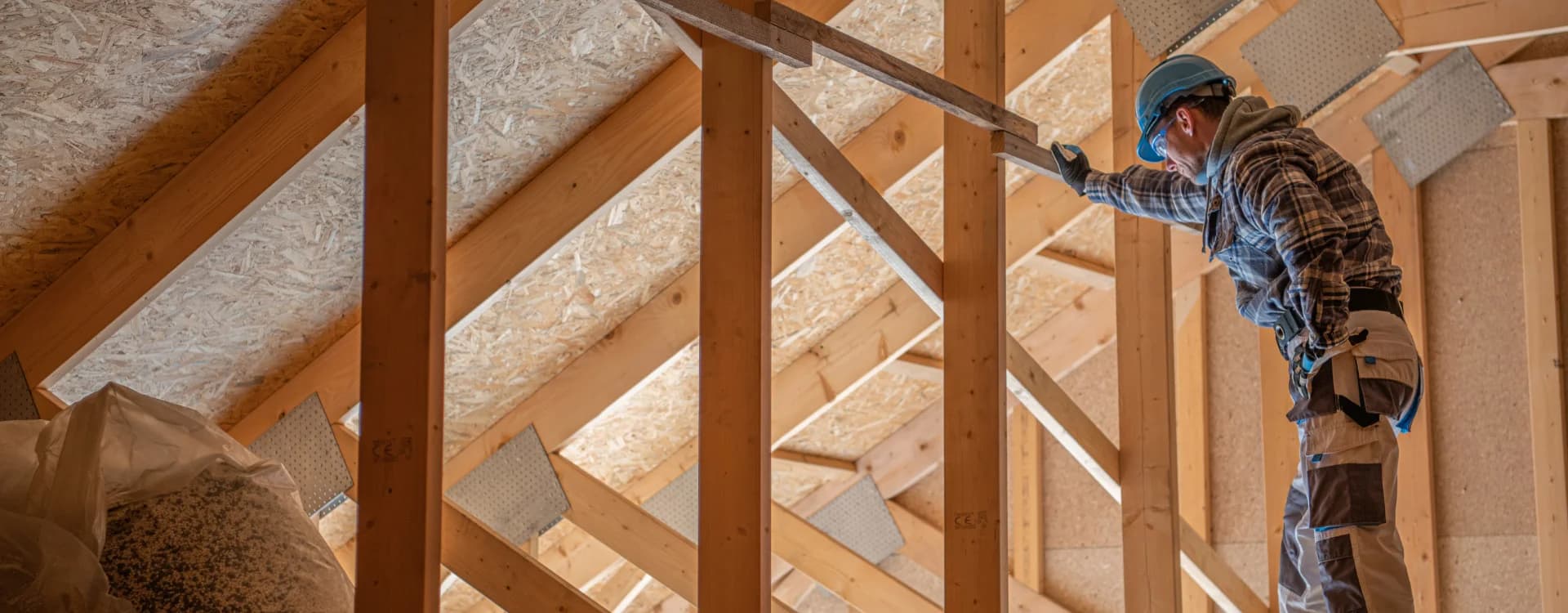 worker-checking-on-wooden-attic-and-roof-structure
