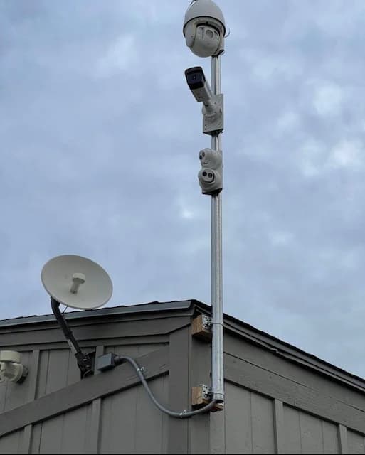Outdoor surveillance camera system mounted on a building pole