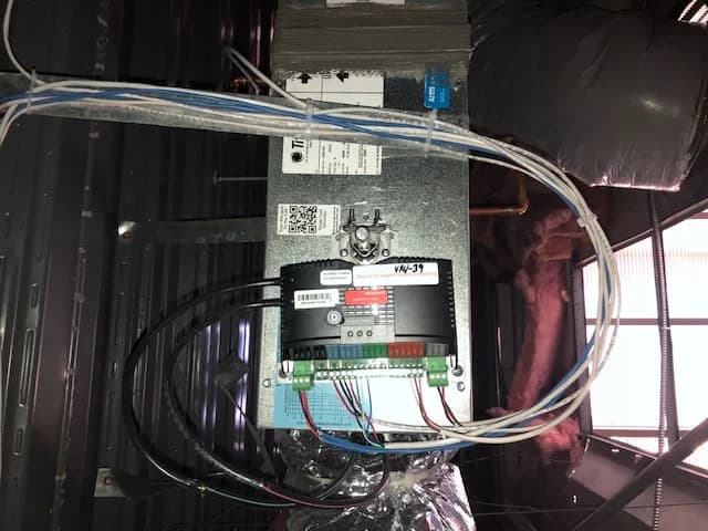 HVAC control board installed above a ceiling or service area
