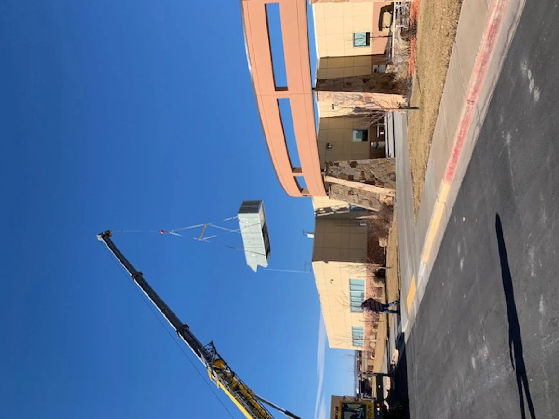 Rooftop HVAC unit lifted by crane at Duchesne County Justice Center during facility upgrade