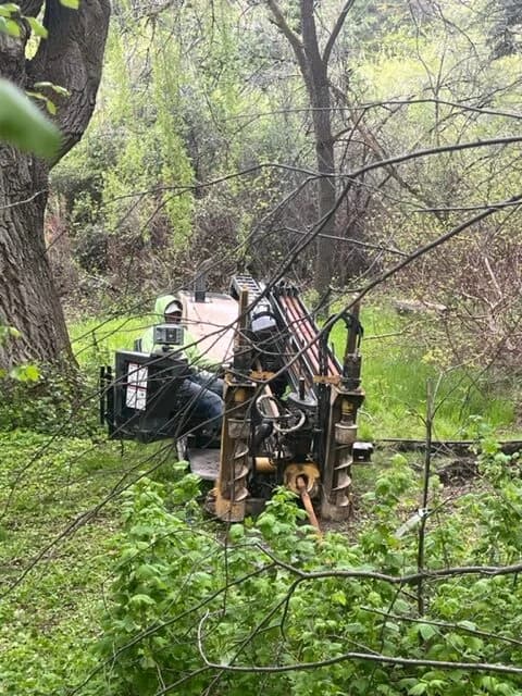 Drilling in the forest for a spring line