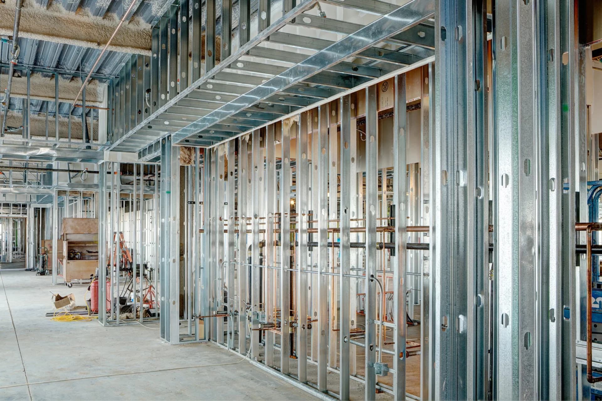 Steel studs with electrical conduit, used to frame in a large commercial building.