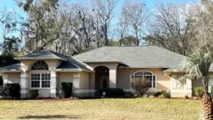 Single-story house with front lawn.