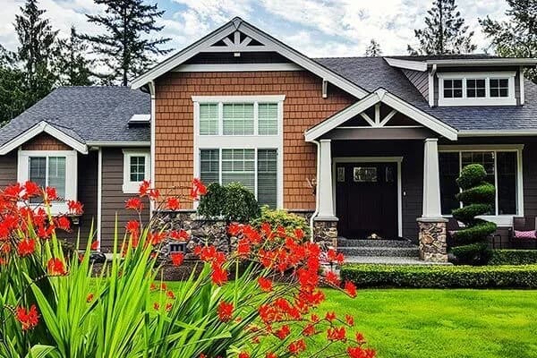 Charming house with red flowers and greenery.